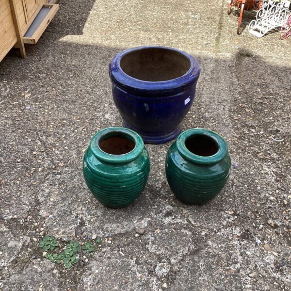 Three teal glazed garden pots for outdoor plants.