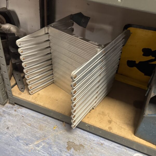 Silver aluminum folding ladder stacked for storage.