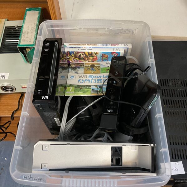 Black Nintendo Wii console with games and controller.