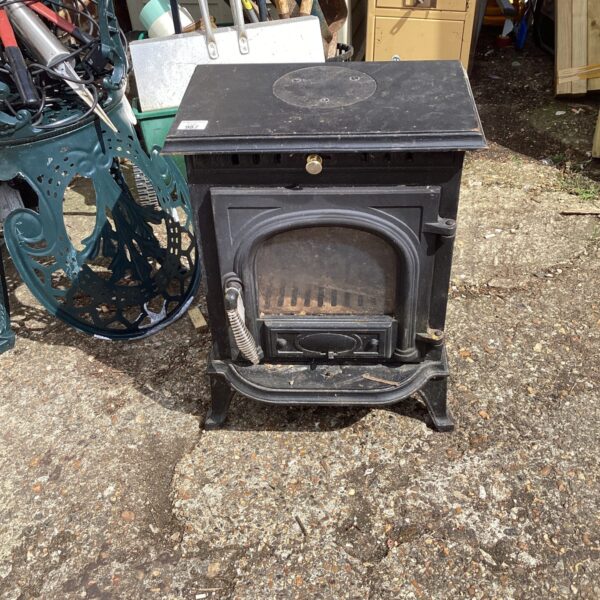 Antique cast iron log burning fire with detailed design.
