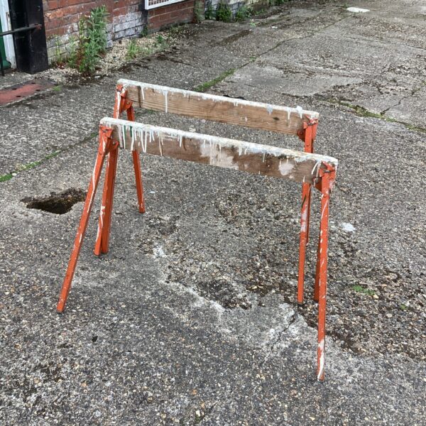 Pair of vintage workmen’s tressels in a garden setting.