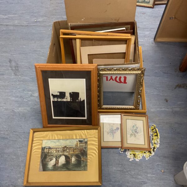 Mixed lot of framed vintage prints and artwork on display.