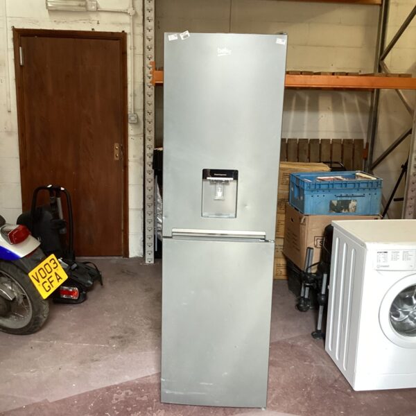 Silver Beko tall fridge freezer in a workshop setting.