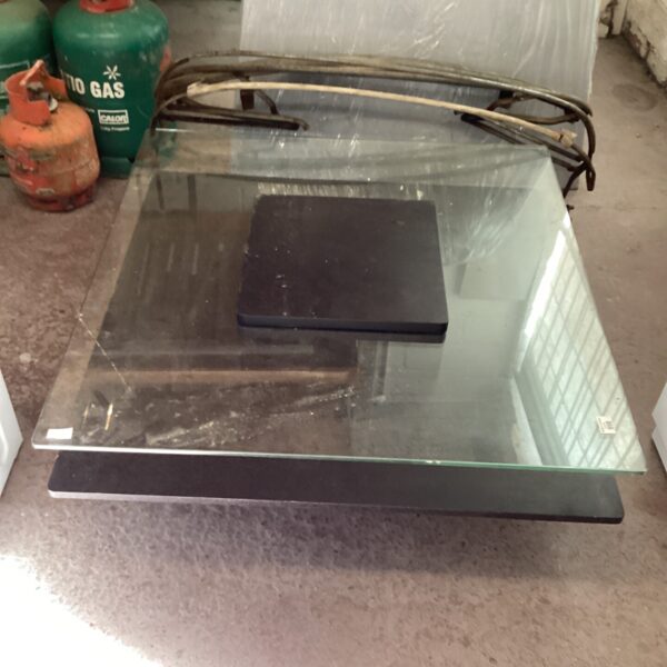 Large low-level glass display table for retail or showroom use.