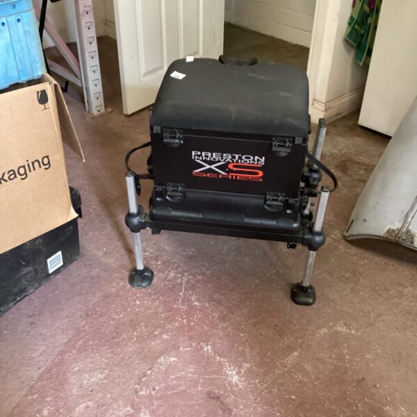 Preston Innovation fishing tackle box with seat and storage.