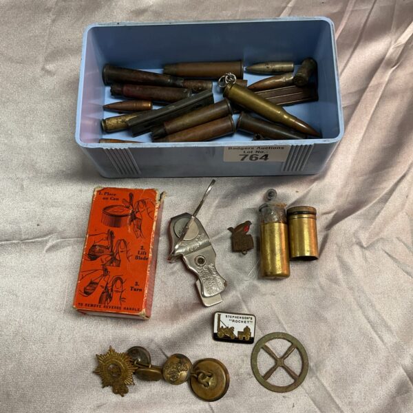 Vintage trench art lot with spent bullets and military badges.