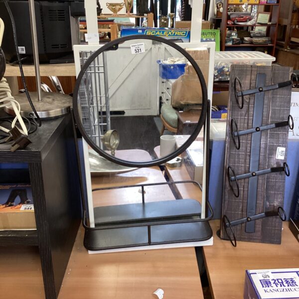 Dark metal framed circular hanging mirror for wall decor.