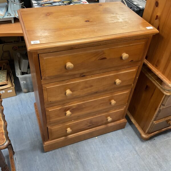 Vintage pine chest of drawers with four drawers, ideal for bedroom storage.