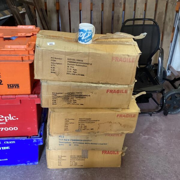 Five boxes of blank sublimation mugs ready for custom printing.