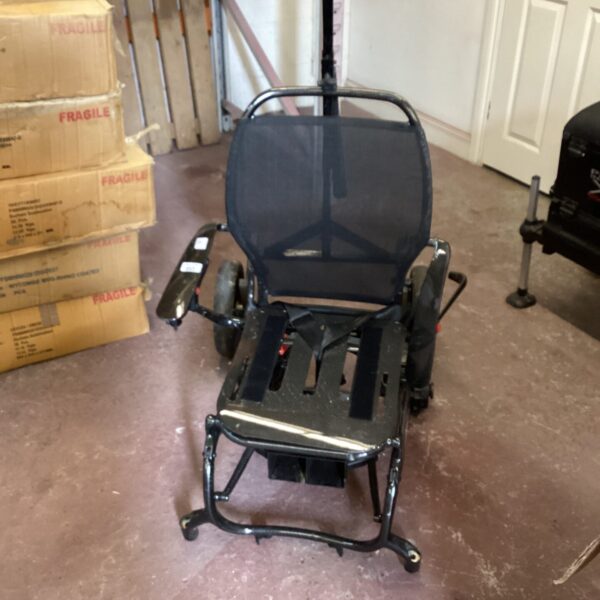 Black mobility scooter for repair, showing frame and seat.