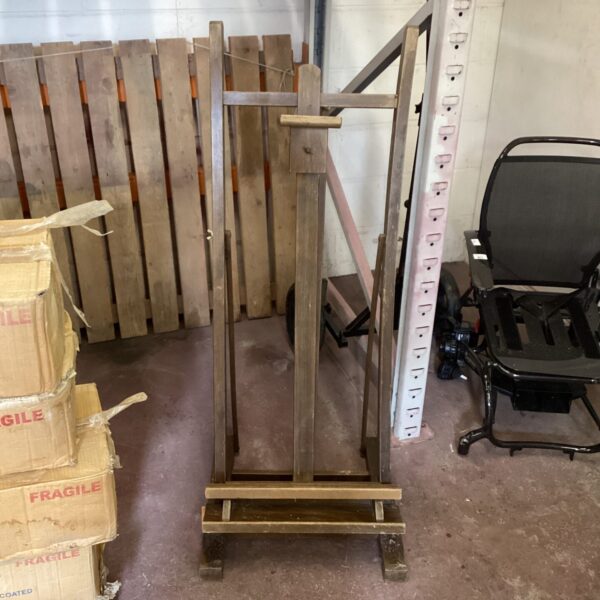 Large wooden artists easel for studio painting and display.