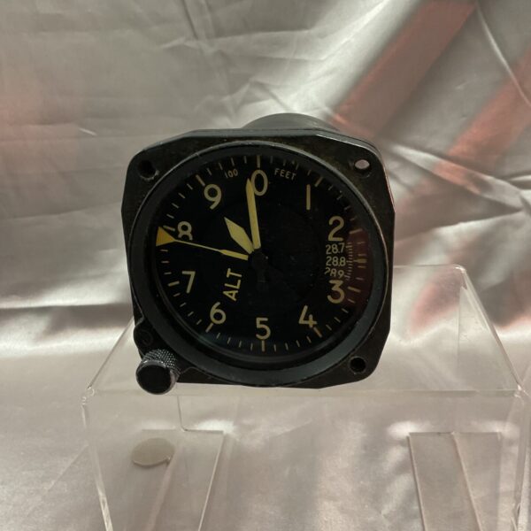 Vintage aircraft altitude gauge showing altitude in feet.