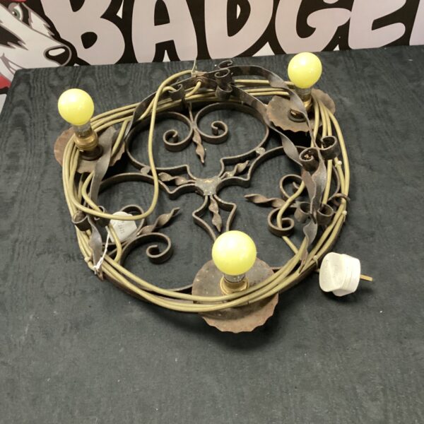 Vintage wrought iron chandelier with multiple lights.