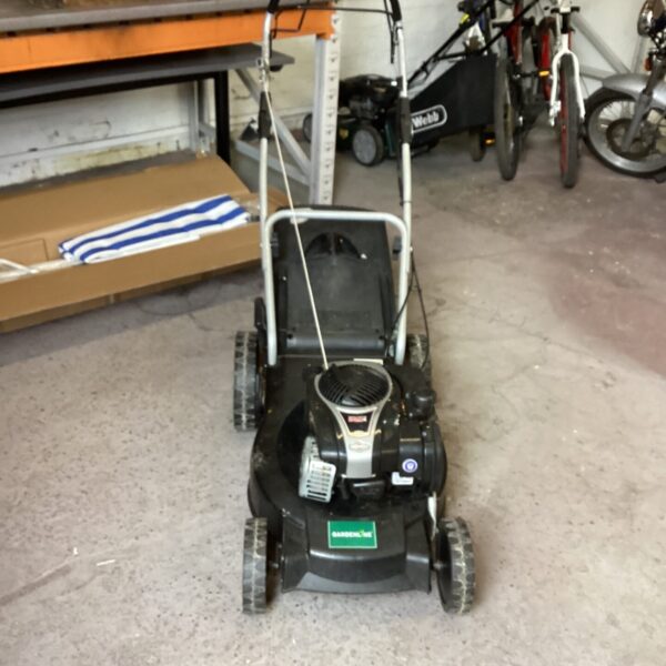 Gardenline petrol lawn mower in a garage setting.