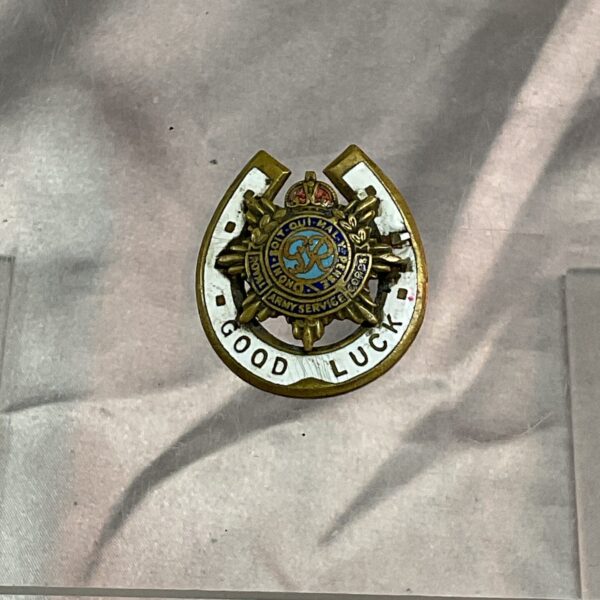 Vintage WWI Royal Army Service Corps enamel brooch with horseshoe design.
