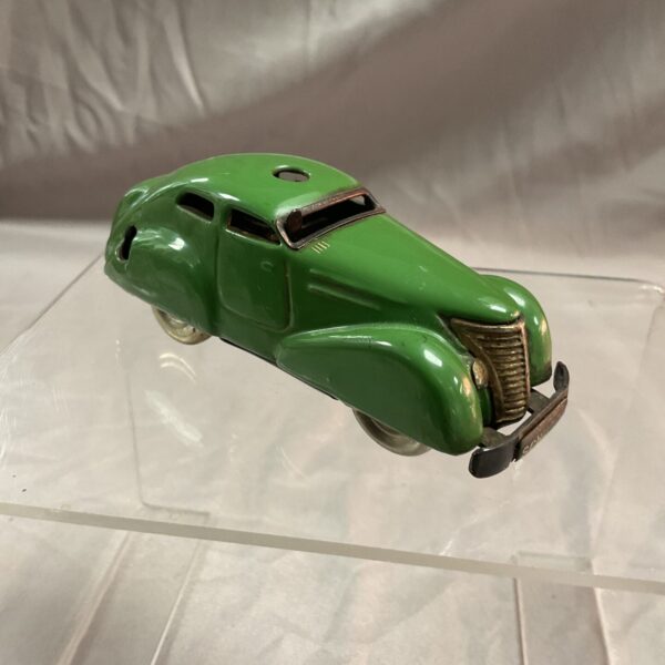 Vintage green Schuco clockwork car, side view.