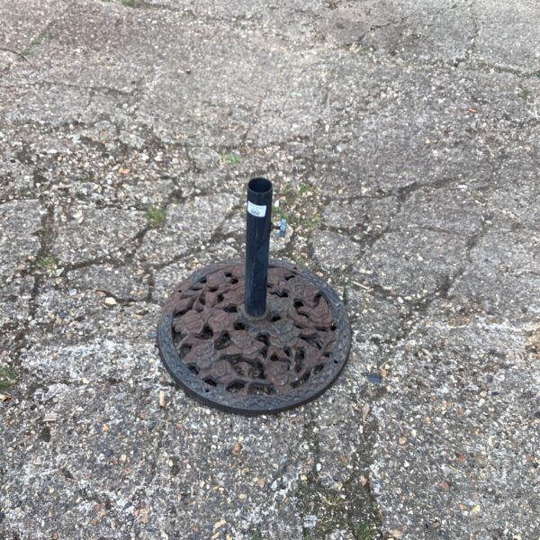 Heavy duty cast iron metal parasol base for garden use.