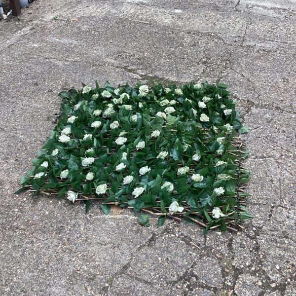 Artificial rose hedge screen for garden privacy and decoration.