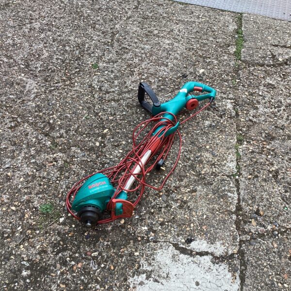 Bosch electric strimmer for garden maintenance and lawn edging.