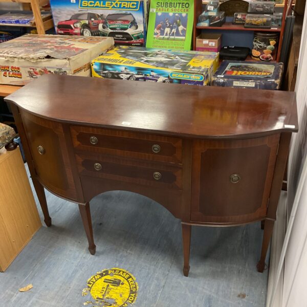 Vintage mahogany sideboard with breakfront design and curved fronts.