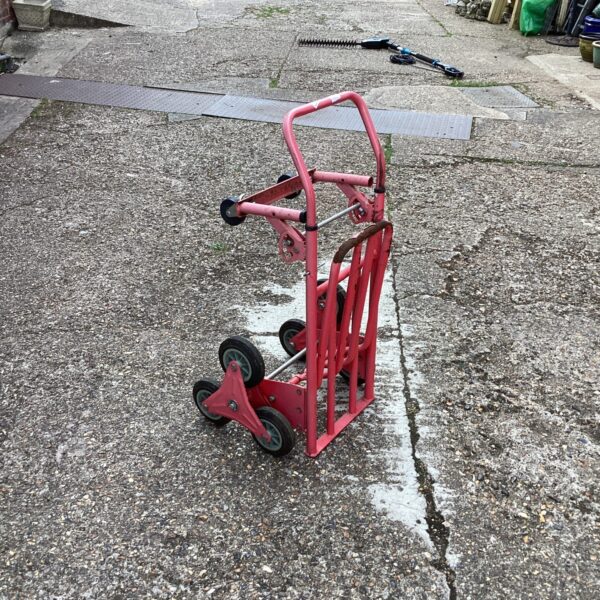 Vintage red sack barrow for repair, ideal for collectors.