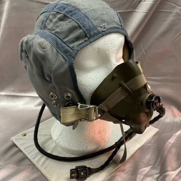 Vintage RAF Type G flying helmet with oxygen mask displayed on a mannequin.
