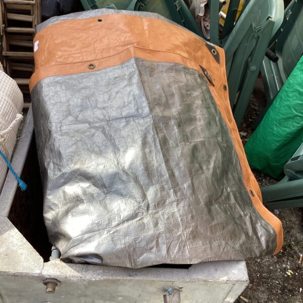Large PVC tarpaulin showing reinforced edges and grommets.