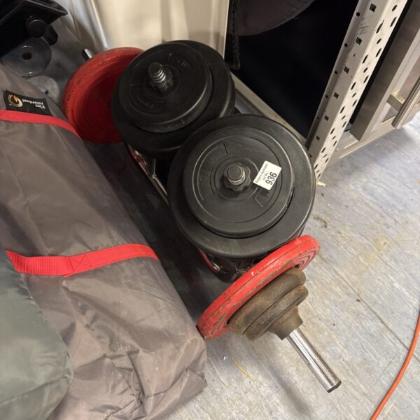 Black cast iron exercise weights and dumbbells for home fitness.