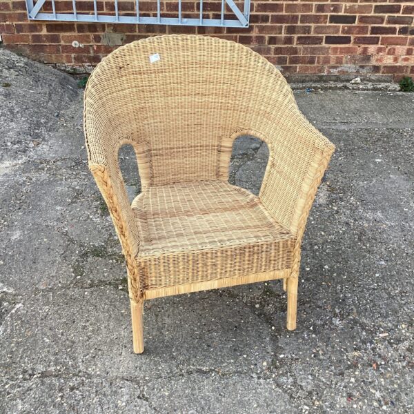 Vintage wicker garden chair with woven seat and back.