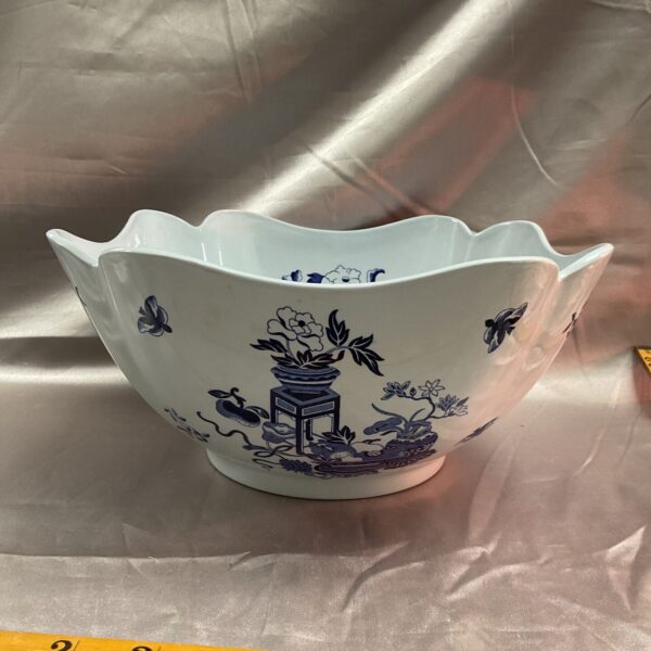 Front view of a vintage blue and white porcelain bowl with landscape design.