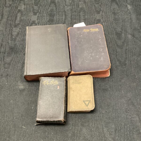 Lot of four antique bibles, vintage religious texts for collectors.