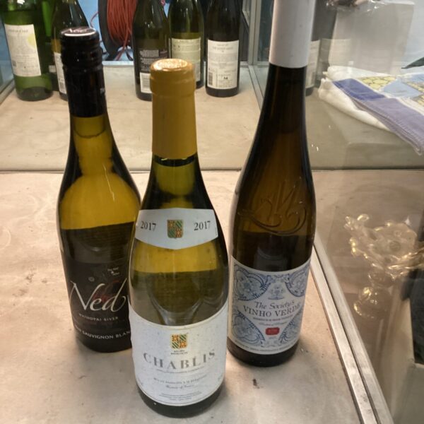 Three bottles of white wine including Sauvignon Blanc, Chablis and Vinho Verde.