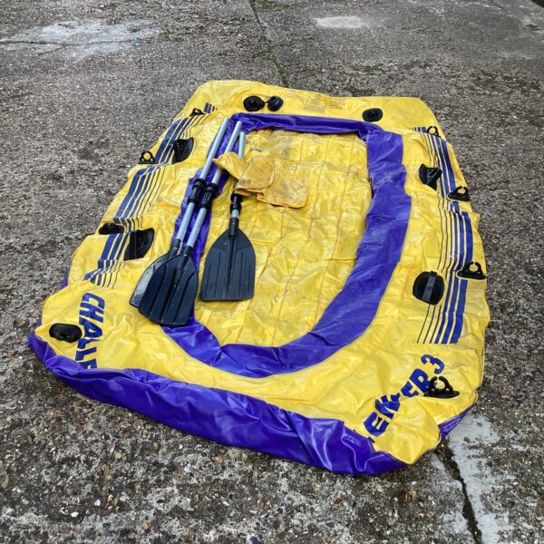 Yellow Challenger Three inflatable boat with paddles.