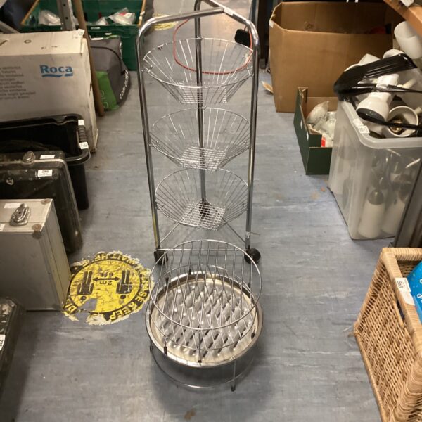 Polished metal wire vegetable rack with four tiers for kitchen storage.