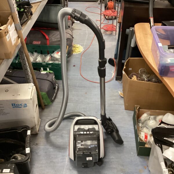 Vintage Miele carpet cleaner with hose attachment.