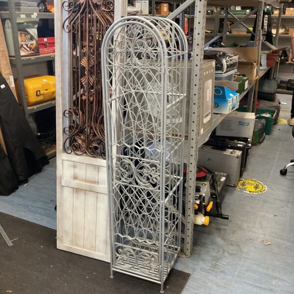 Tall metal wine rack holding 38 bottles for stylish storage.