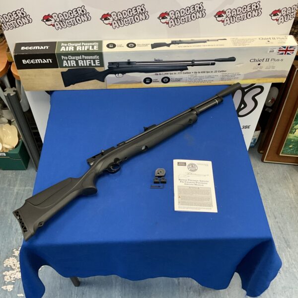 Beeman Chief II Plus-S pre-charged pneumatic air rifle on blue surface.