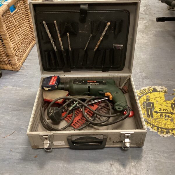 Vintage Bosch hammer drill in carrying case with drill bits.