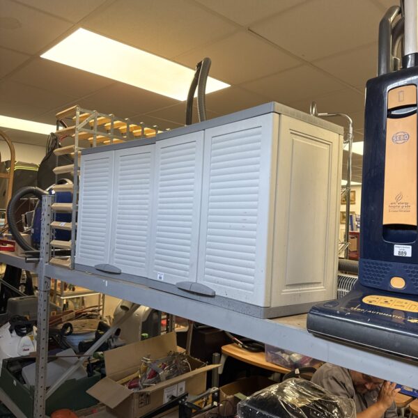 Two medium-sized plastic garden storage cabinets for outdoor use.