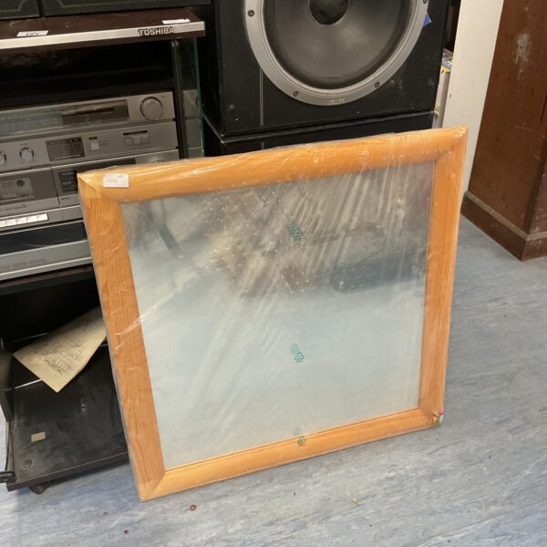 Square beech framed mirror with a simple design.