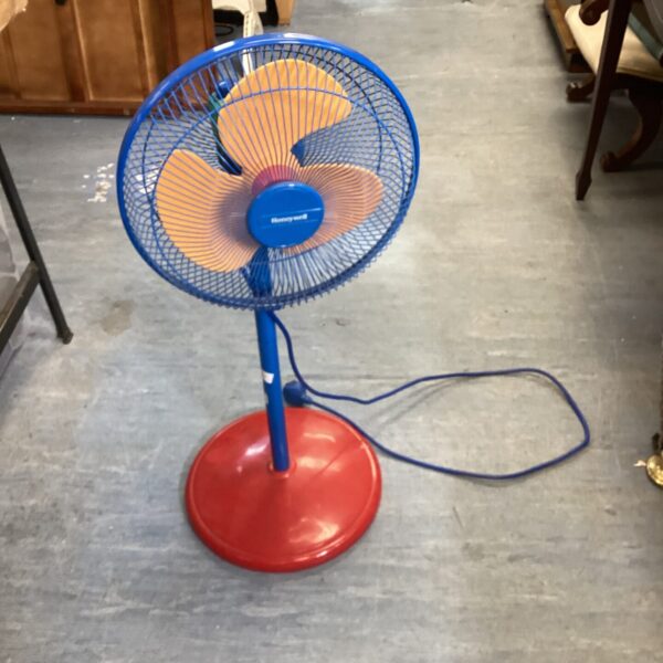 Vintage Honeywell floor fan with red base and blue body.