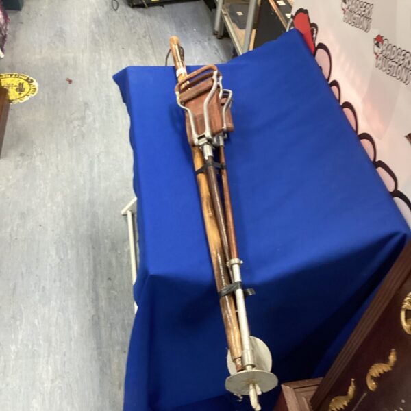 Antique shooting sticks and walking staff on a blue background.