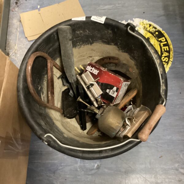 Vintage tool lot in a black bucket, including door locks and wrenches.