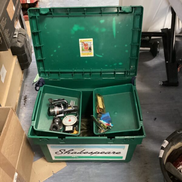 Green Shakespeare fishing tackle box open with contents visible.
