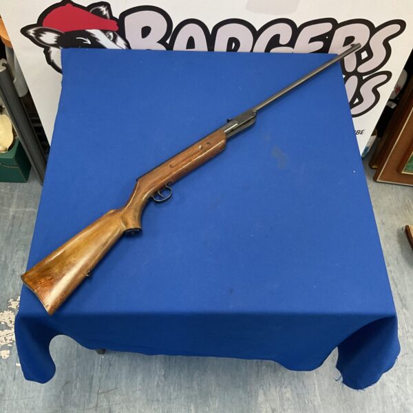 Vintage Jelly 5.5 calibre breakbarrel air rifle on a blue surface.