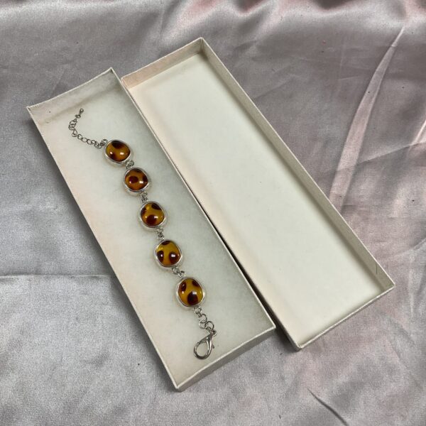Vintage silver tone bracelet with amber style glass cabochons.