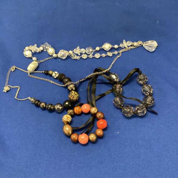 Vintage beaded jewellery lot with colourful necklaces and bracelets.
