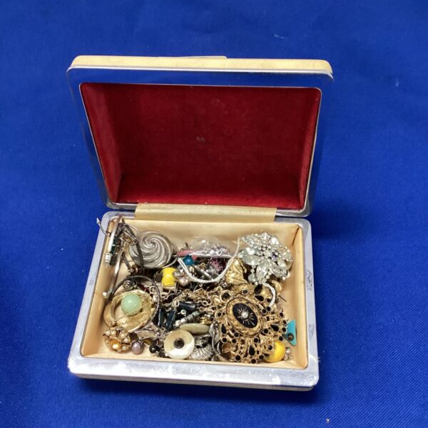 Assortment of vintage costume jewellery including brooches and earrings.