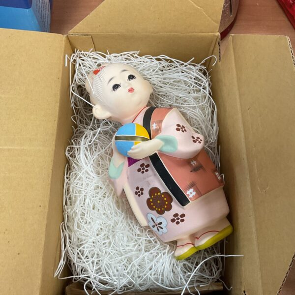 Vintage Chinese porcelain figure of a child with a ball.
