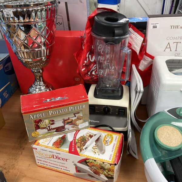 Vitamix blender with potato peeler and dicer attachments displayed.